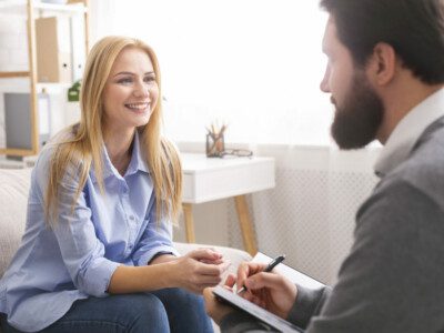 smiling-woman-during-consultation-with-life-coach